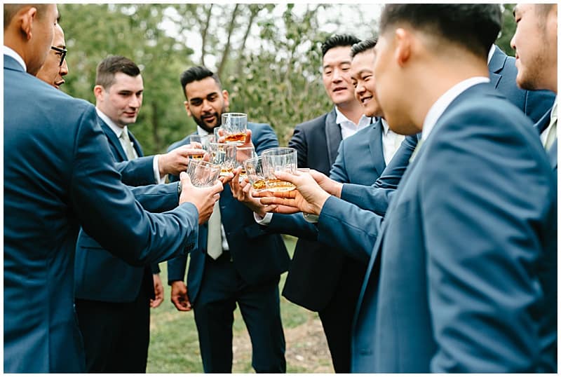 groom and groomsmen making a toast
