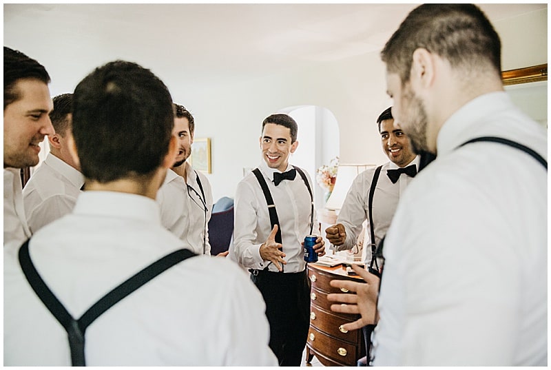 groom drinking beer with his groomsmen before the wedding ceremony