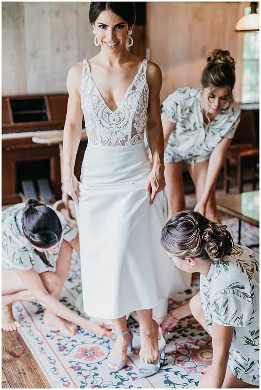 bridesmaids helping the bride get ready for her wedding ceremony
