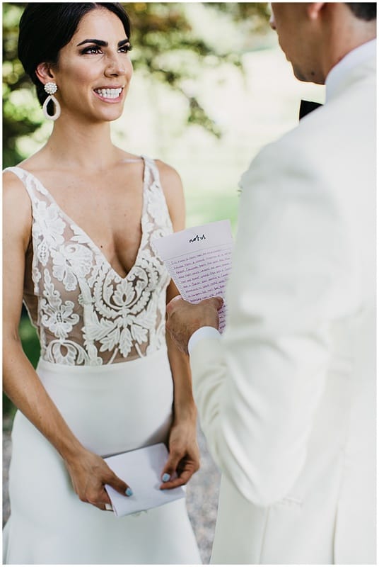 bride and groom reading each other letters during their first look