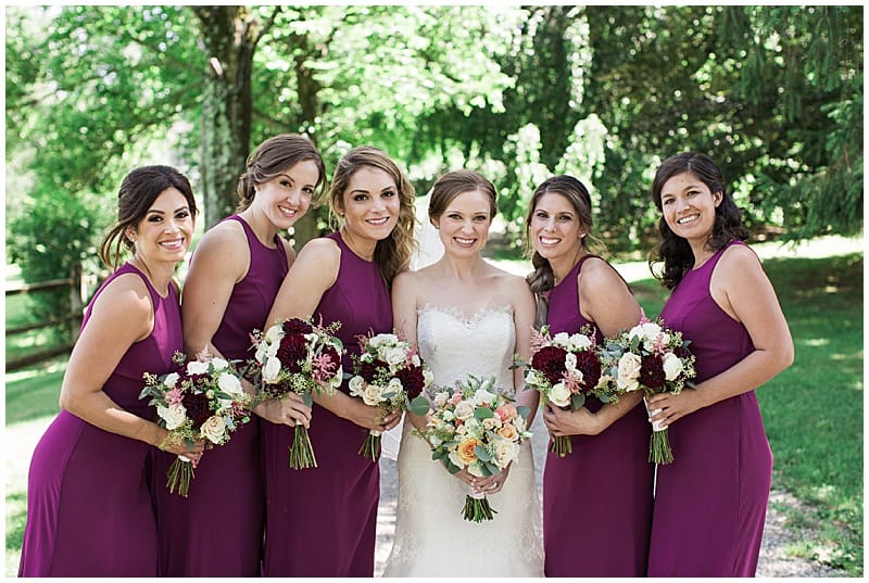 bride and the bridesmaids holding their bridal bouquets