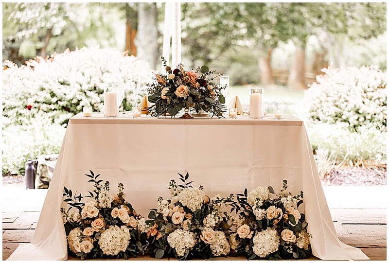 sweetheart table with wedding floral decor