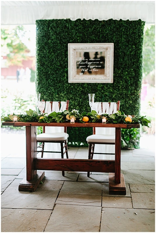 sweetheart table decor with greenery backdrop