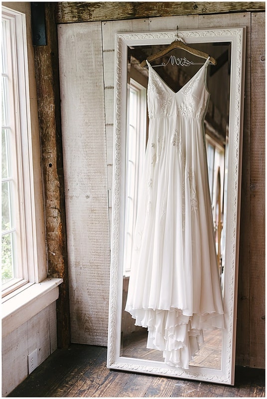bride's wedding dress hung up before the wedding