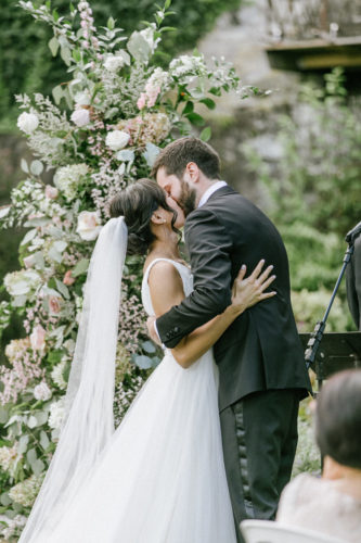 bride and groom share first kiss after saying I do