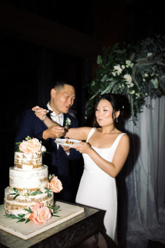 bride and groom share wedding cake