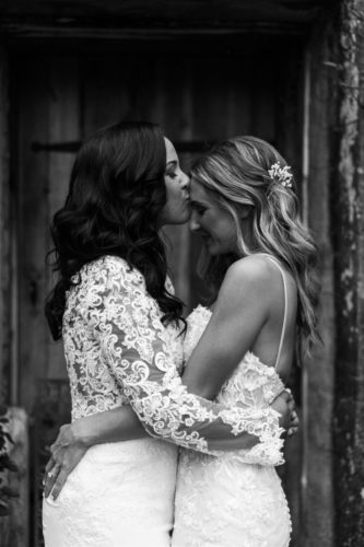 two brides embracing