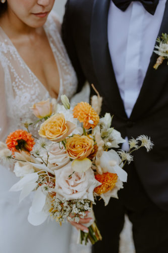 close up of bride and groom with wedding bouquet