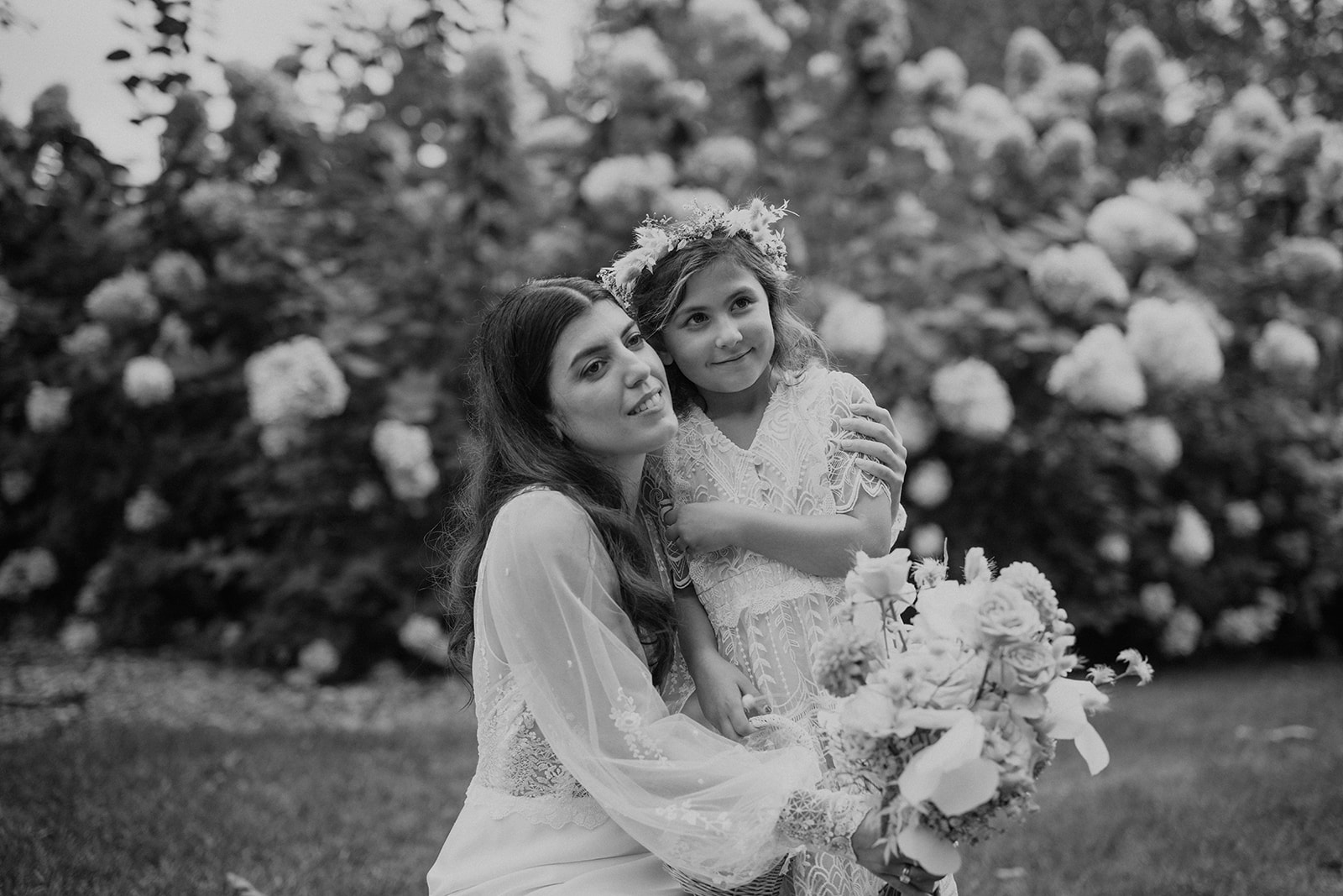bride and the flower girl embrace