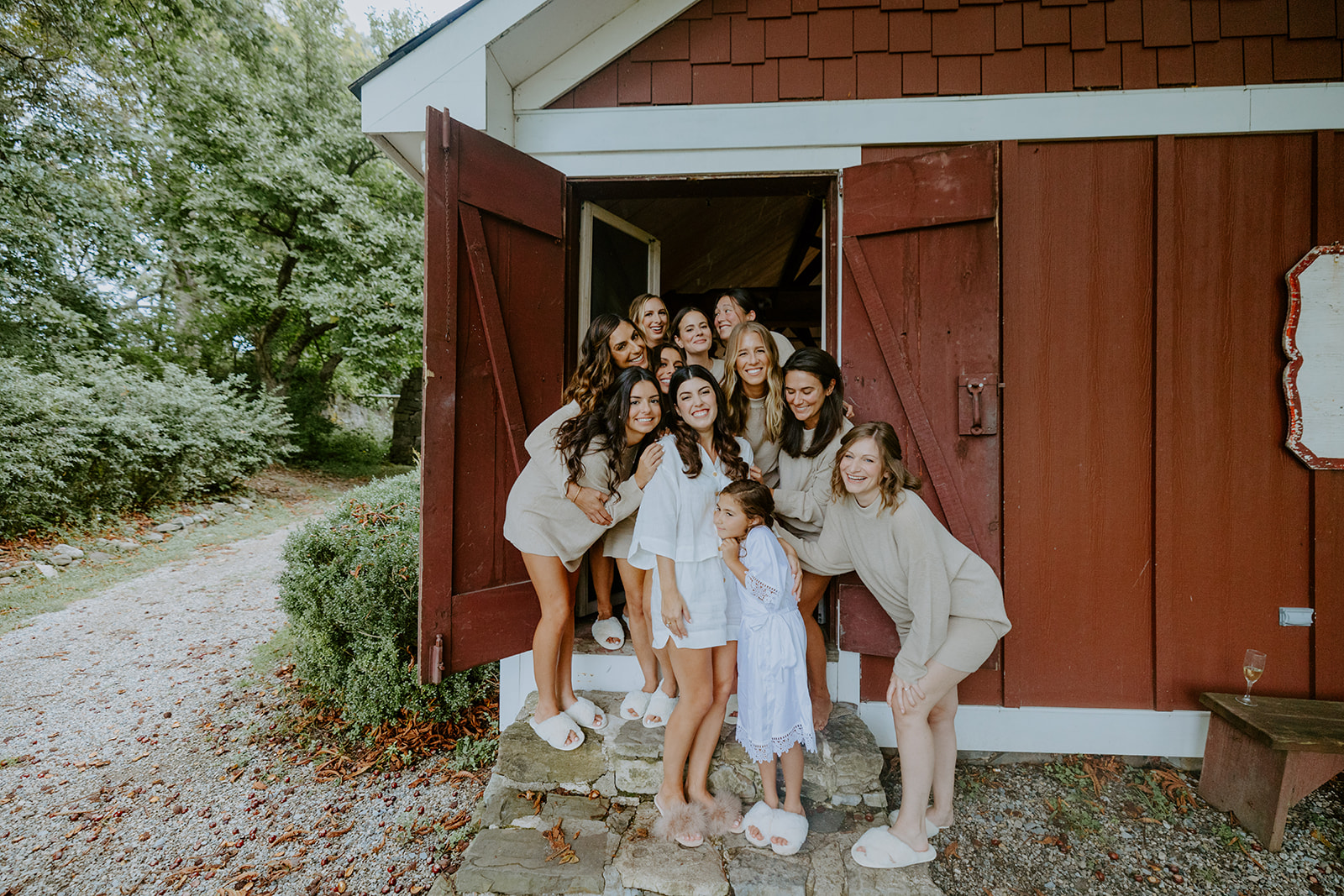 bride and bridesmaids in front of barn