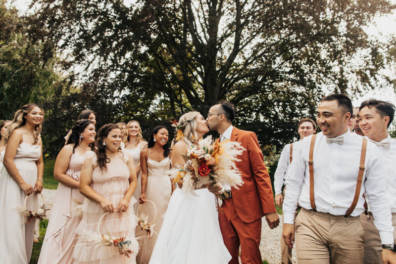 bride and groom walk with bridal party