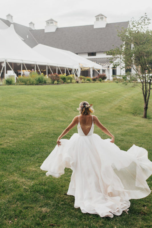 bride runs with flowing wedding dress behind her
