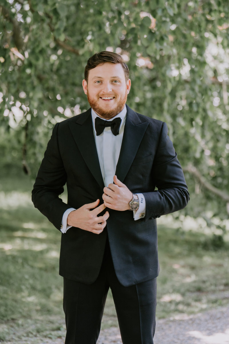 groom on his wedding day in black suit and bow tie