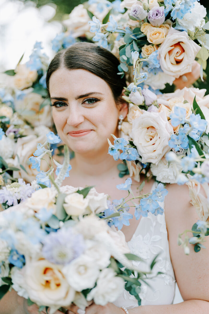 something blue in floral arrangements surrounding the bride