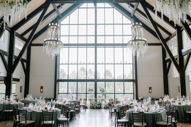 Crossed Keys Estate Farmhouse, Andover NJ. Floor to celling windows with lit candles, hanging wistera from chandeliers