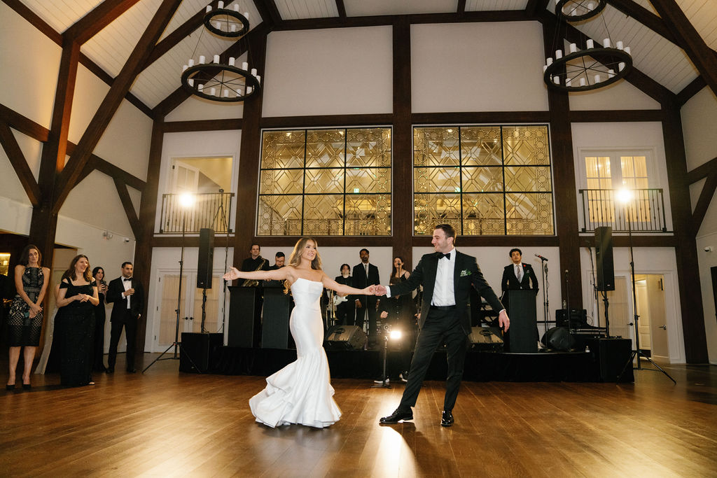 Dancing under chandeliers in the Farmhouse at Crossed Keys Estate