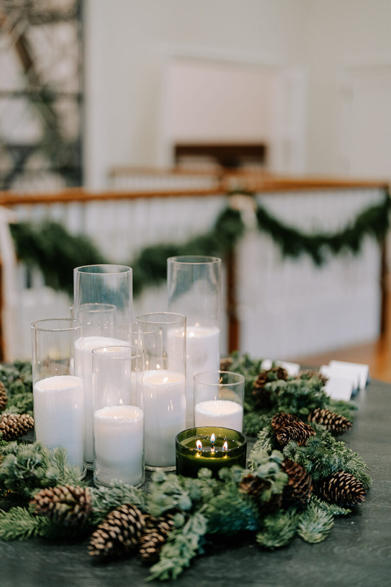 Farmhouse entrance decorated with wreaths, garlands, and twinkling trees for December wedding