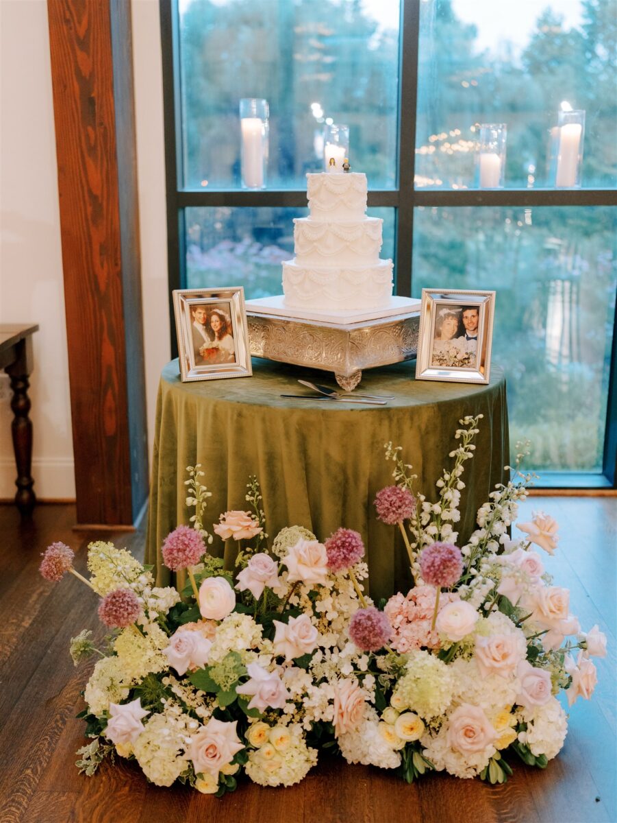 Wedding Cake Table with floral arrangement and tribute to parents of the bride and groom