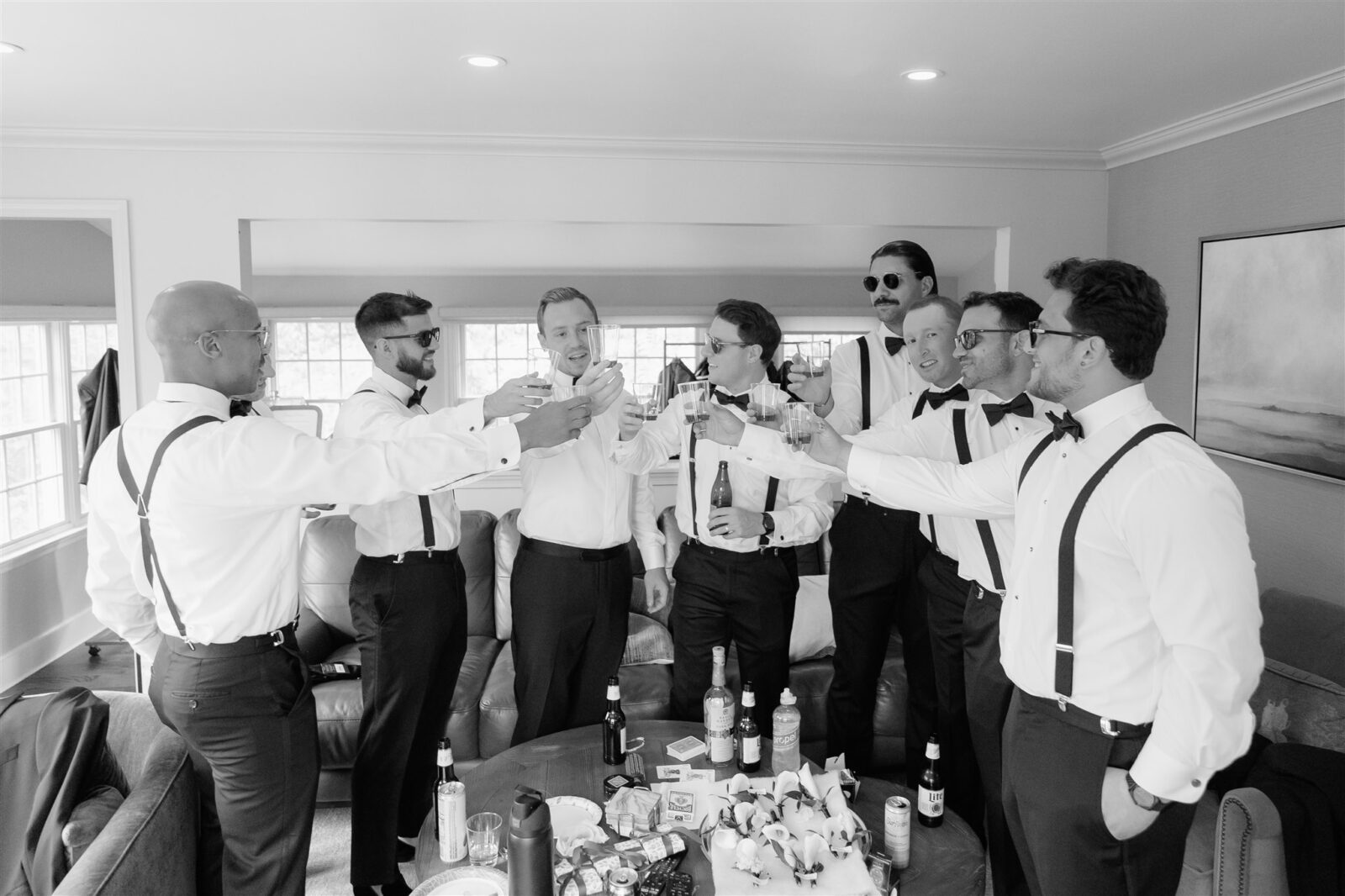Black and White Photo of Groomsmen toasting to a beautiful wedding day