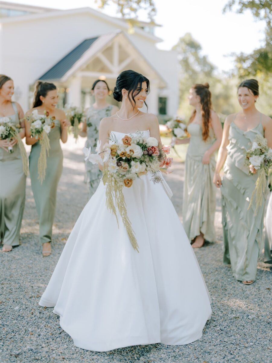 Bride Holding Bridal Bouquet with Bridesmaids holding smaller matching bouquets