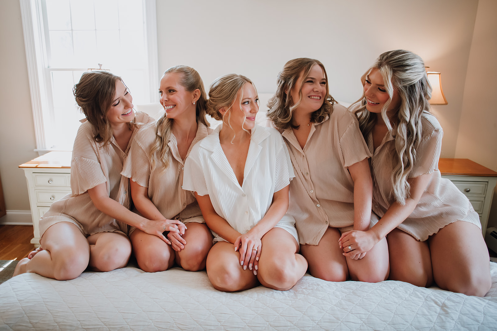 Bride and bridesmaids posing for a portrait while getting ready at Crossed Keys Inn before winter wedding ceremony