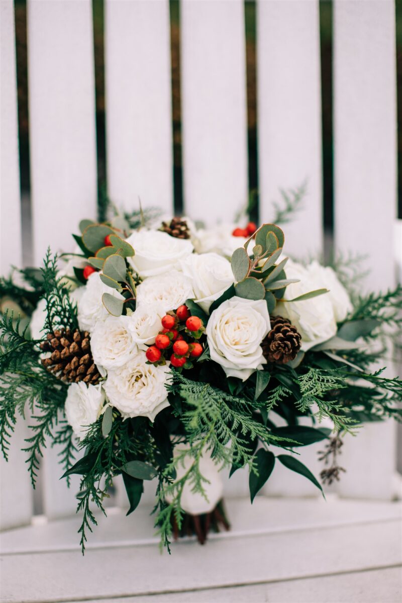 White Winter Bridal Bouquet with greenery, pinecones and berries