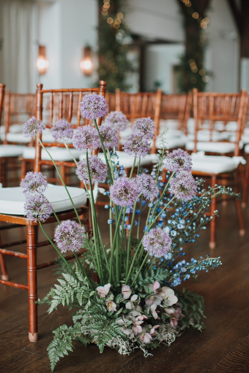 whimsical winter woodland wedding aisle marker with allium flowers