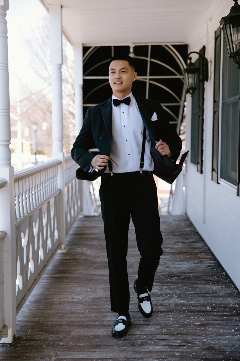 Groom wedding ready at Crossed Keys Inn before winter wedding reception