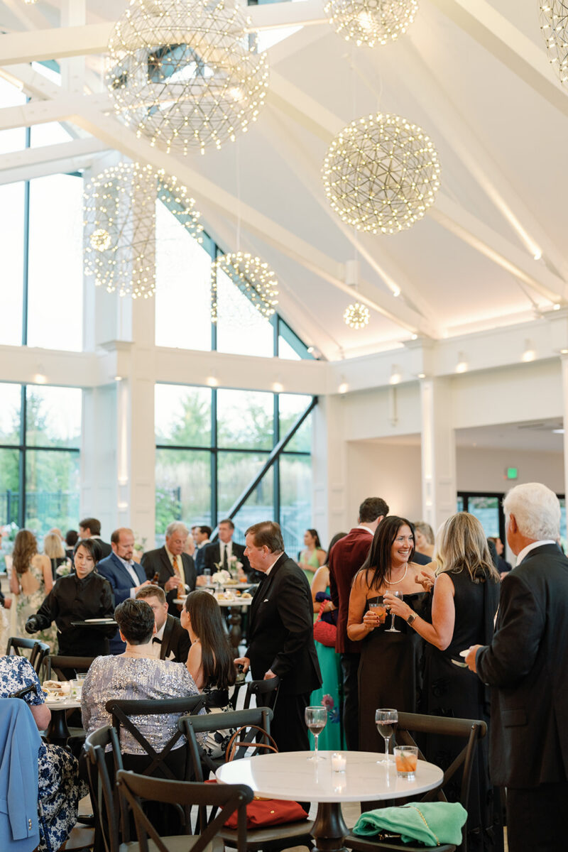 Cocktail hour in glass Conservatory at Crossed Keys Estate with guests mingling