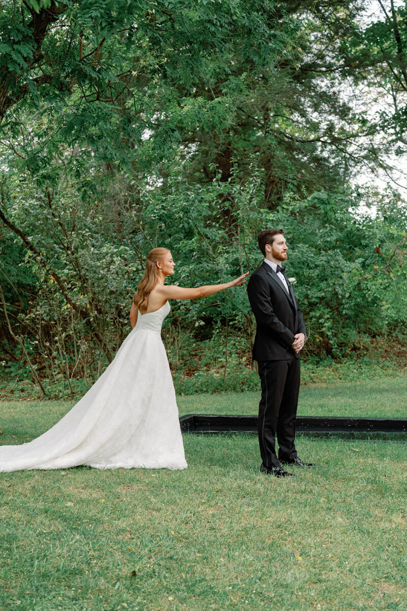 First look at the reflection pond with bride and groom at Crossed Keys Estate