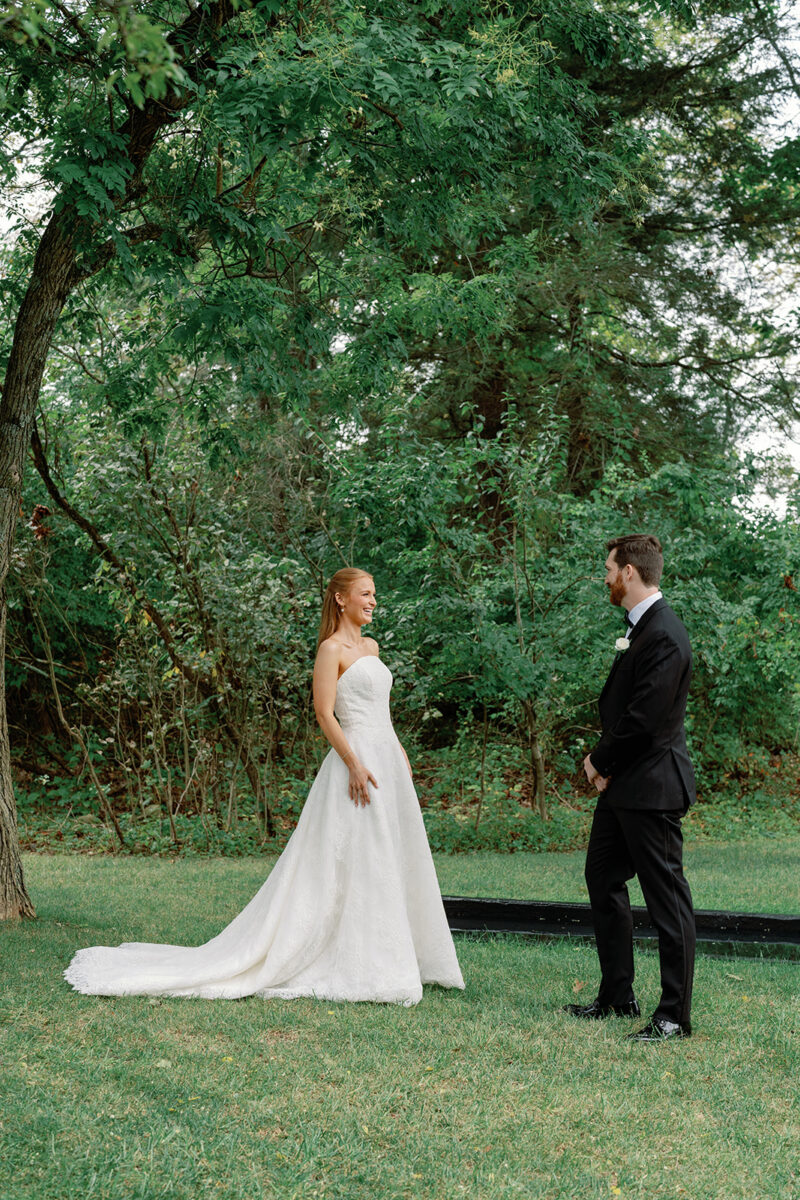 First look at the reflection pond with bride and groom at Crossed Keys Estate