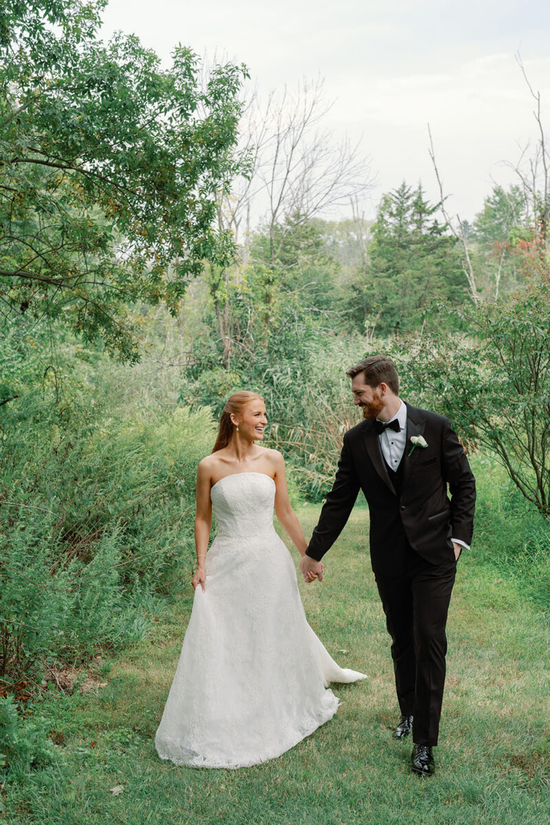 Couple walking portrait surrounded by greenery