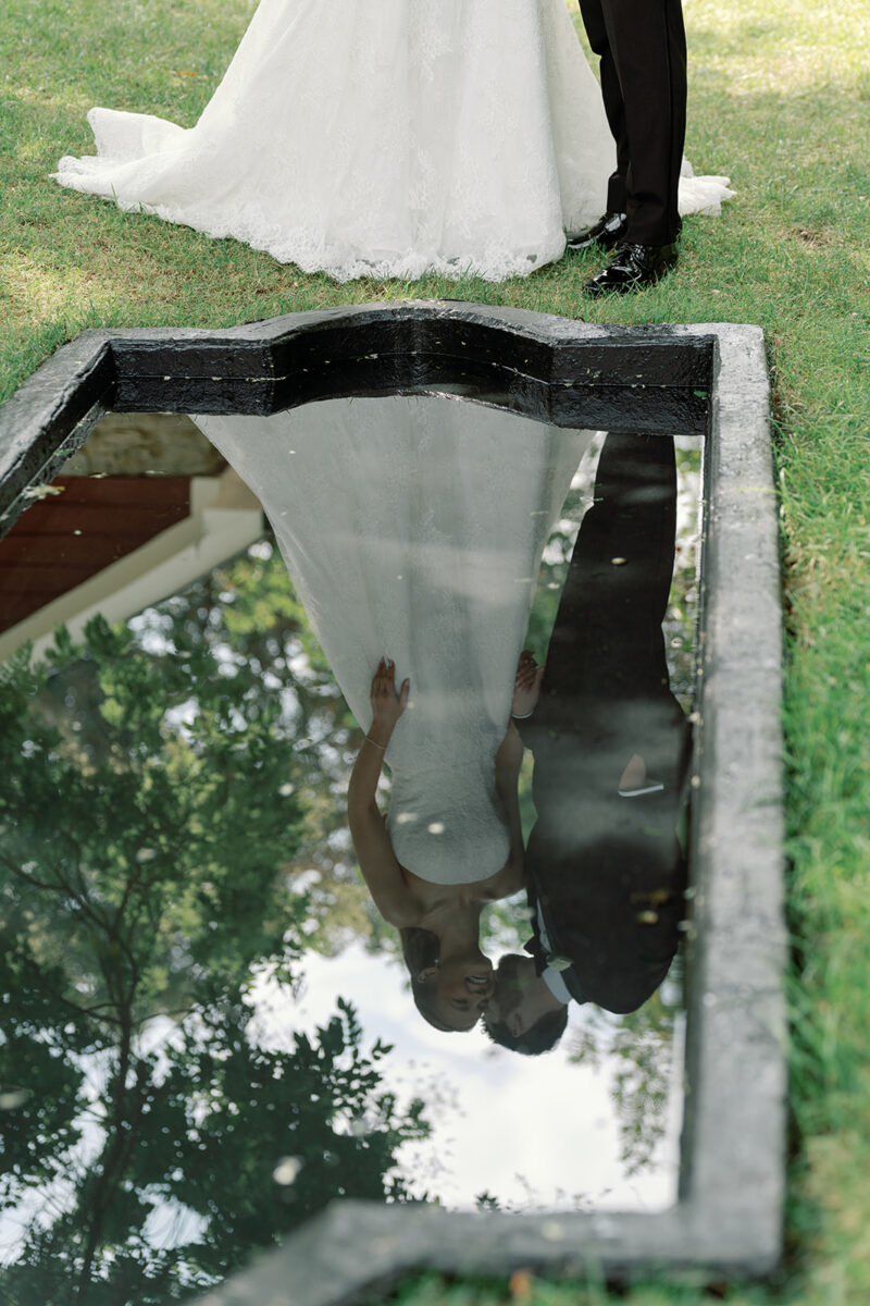 First look at the reflection pond with bride and groom at Crossed Keys Estate