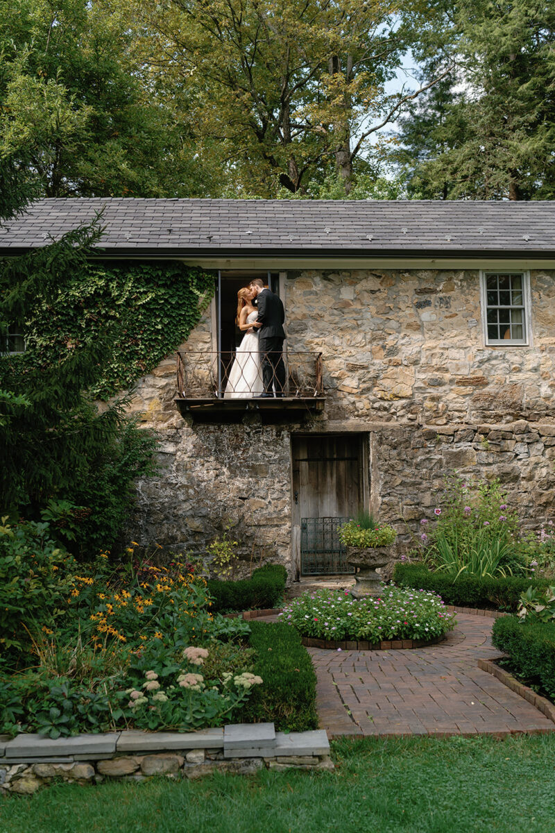 Romantic Wedding Portraits. English Stone Garden Wedding Venue. Wedding portraits on the Playhouse balcony overlooking gardens at Crossed Keys Estate. September Garden Wedding