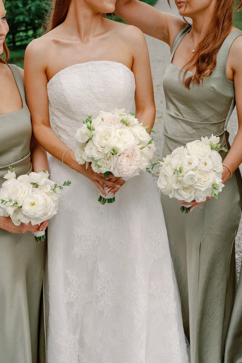 Blush Bridal and bridesmaid bouquets. Bridesmaids in sage green dresses holding white bouquets at Crossed Keys Estate