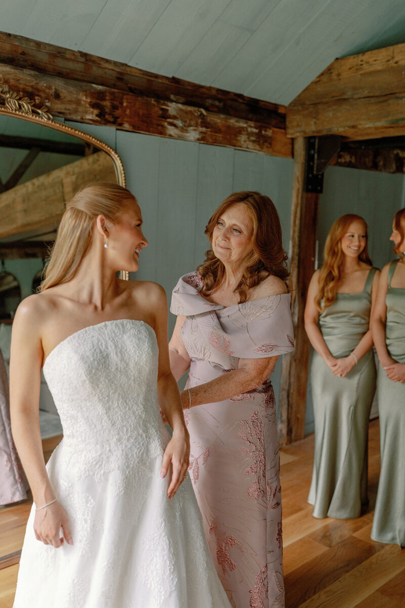 Mother of the bride admiring her beautiful daughter after helping her with get into her Anne Barge lace wedding gown. Crossed Keys Estate Playhouse Getting Ready Suite
