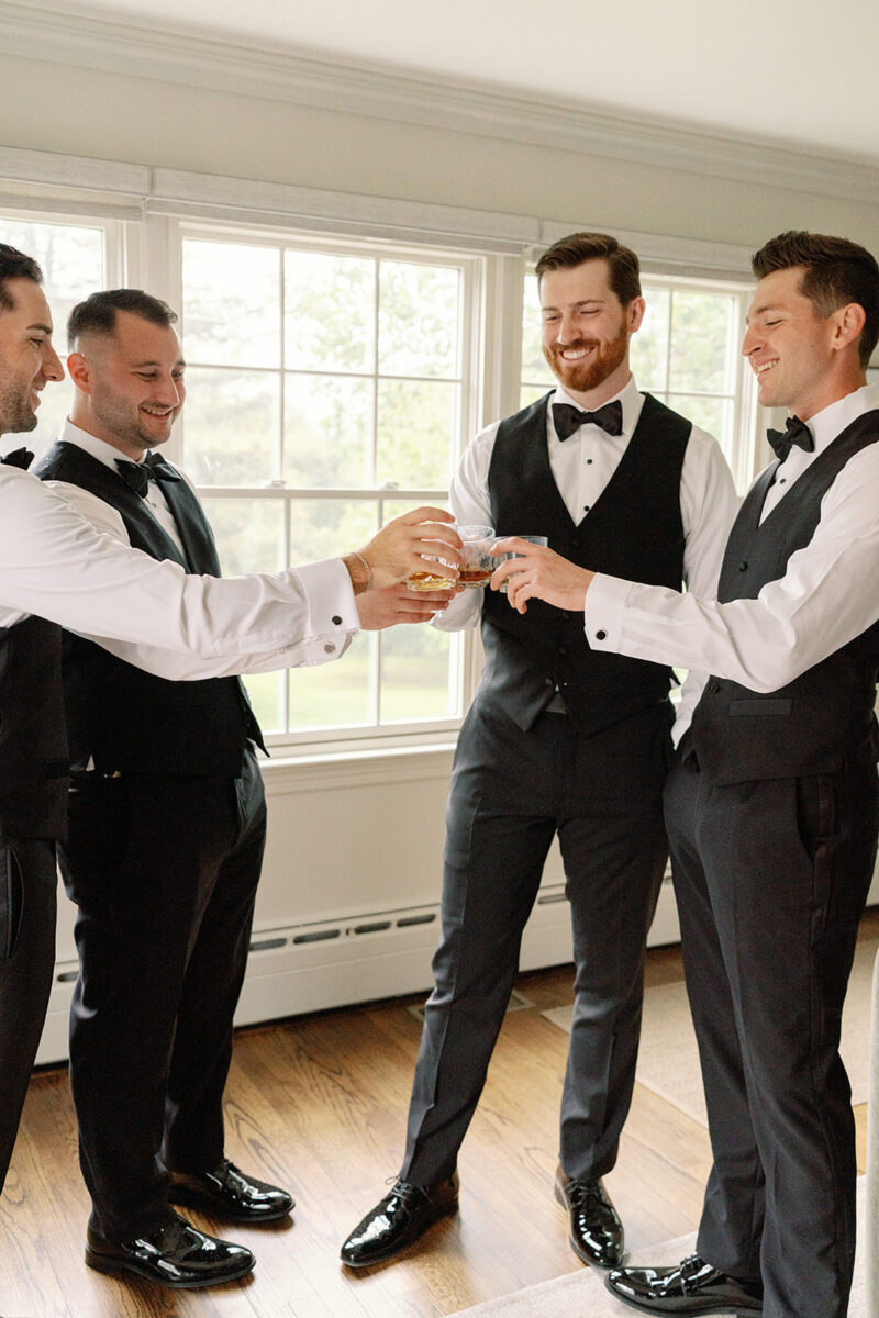 Groom and groomsmen getting ready in Pequest Parlor at Crossed Keys Estate