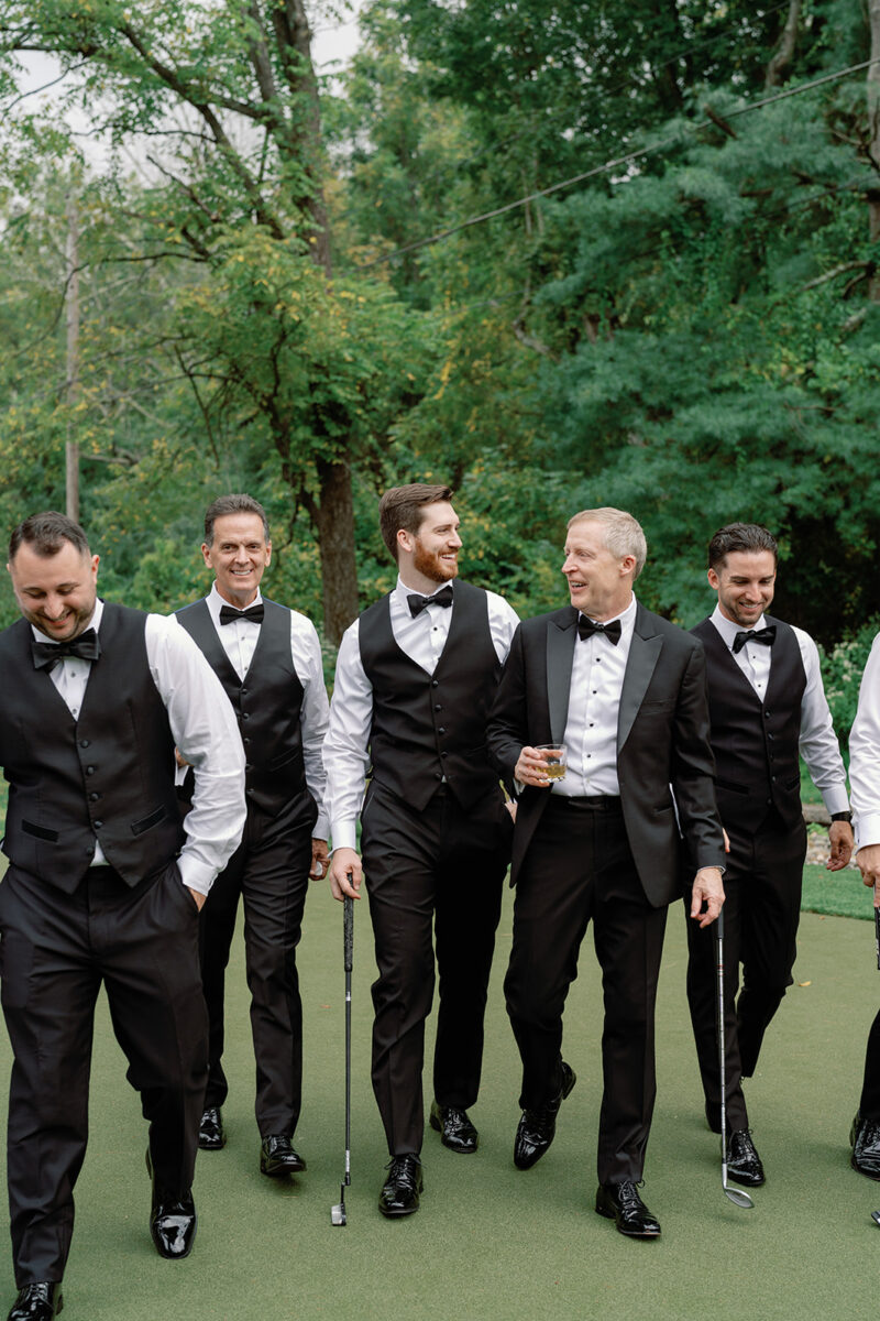 Groom on putting green at Crossed Keys Estate before garden ceremony
