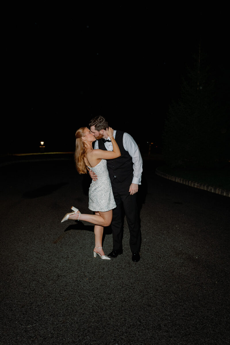 Newlywed couple sneaking away for late night wedding portraits on the grounds at Crossed Keys Estate