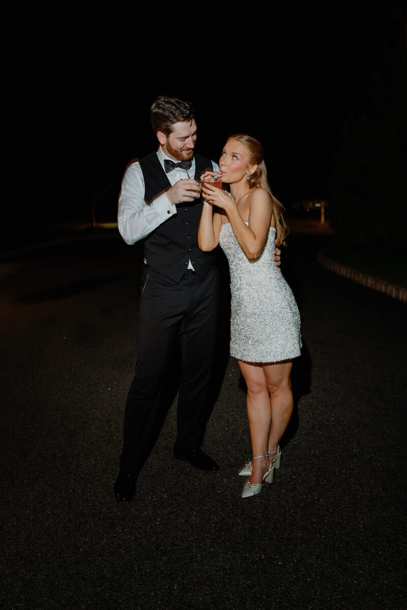 Newlywed couple sneaking away for late night wedding portraits on the grounds at Crossed Keys Estate