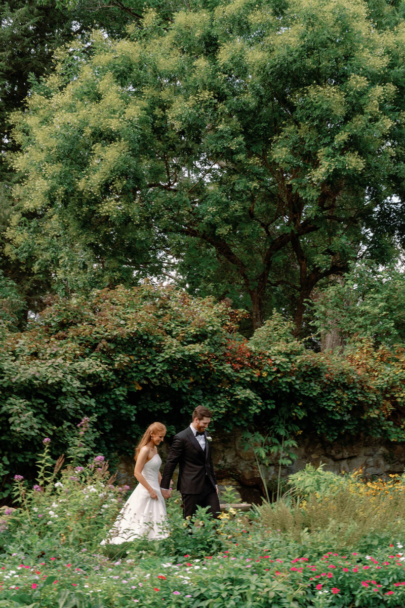 Candid wedding portraits in the September garden before their wedding ceremony