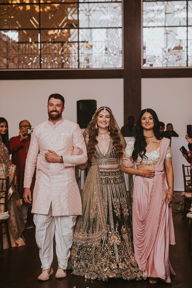 Indian bride walking the aisle during wedding ceremony processional inside Crossed Keys Estate upscale Farmhouse NJ venue