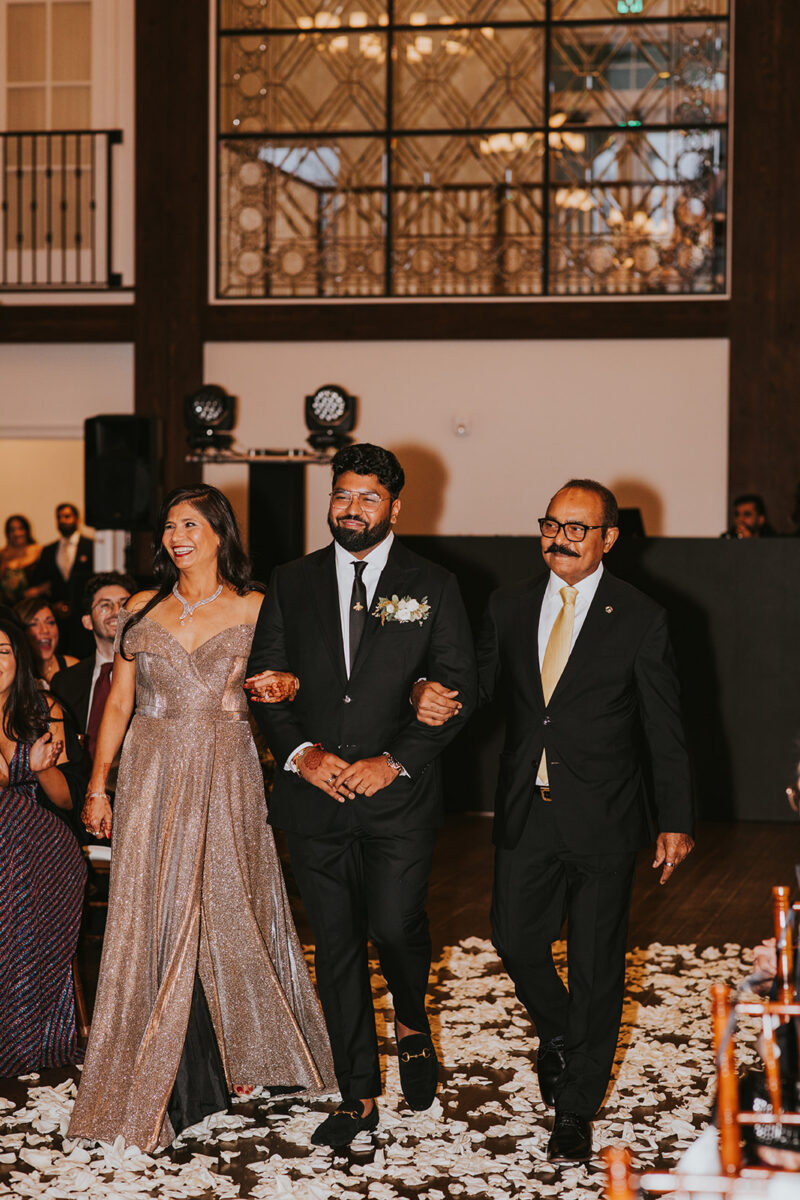 Groom in custom black suit walking the aisle in an American wedding ceremony upscale NJ wedding venue