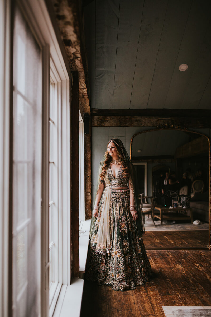 Bride's heavily beaded Kalki olive green lehenga Indian wedding fashion in Crossed Keys Estate's Playhouse Getting Ready Suite
