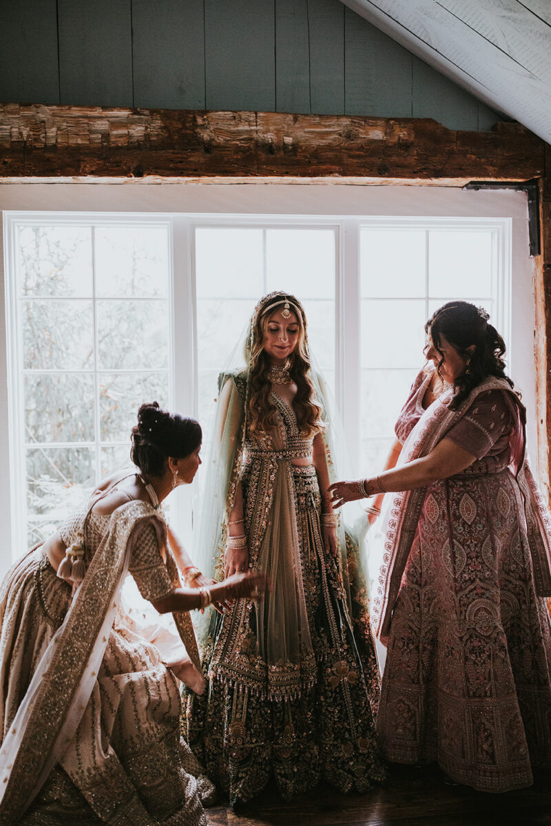 Bride's heavily beaded Kalki olive green lehenga Indian wedding fashion in Crossed Keys Estate's Playhouse Getting Ready Suite