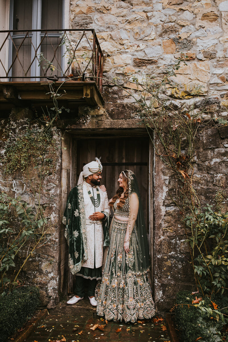 Multicultural wedding couple embracing fall garden setting Crossed Keys Estate