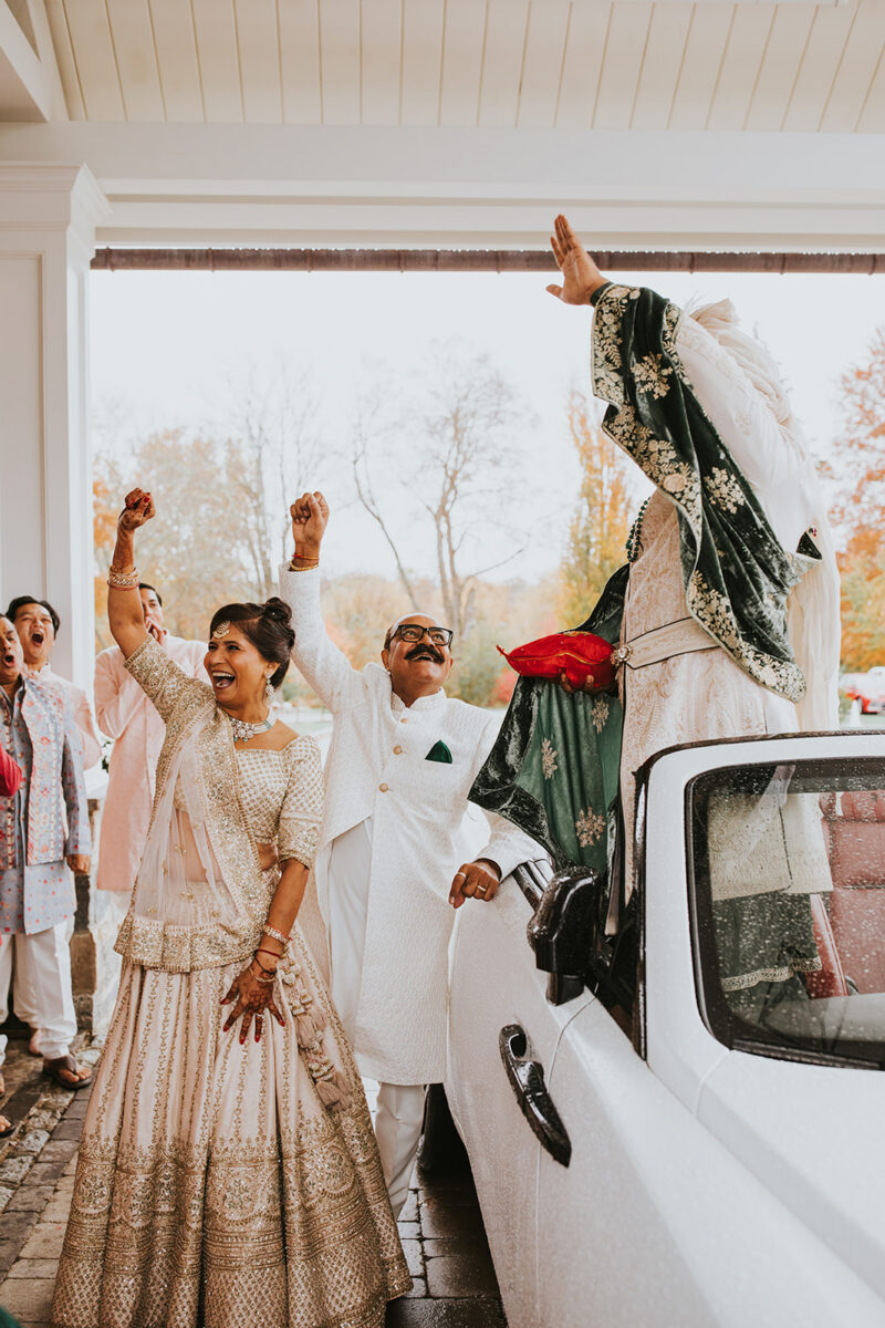 Indian wedding baraat celebration with groom in embroidered sherwani at New Jersey garden estate