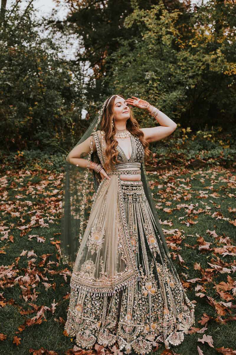 Bride Shannon in olive green velvet lehenga portrait before Hindu ceremony Crossed Keys Estate