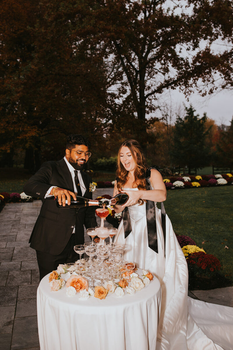 Fall wedding reception with rosé champagne tower at upscale New Jersey garden estate venue