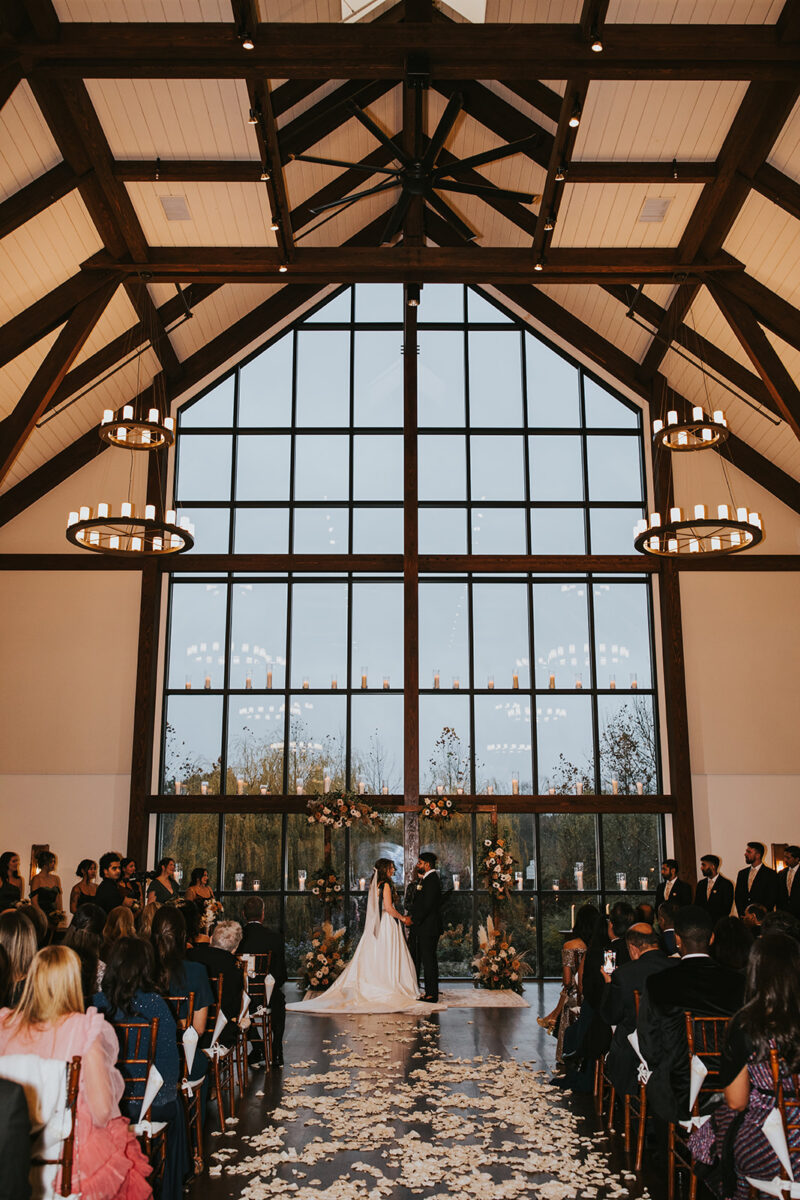 Farmhouse windows backdrop during couple's multicultural fall wedding